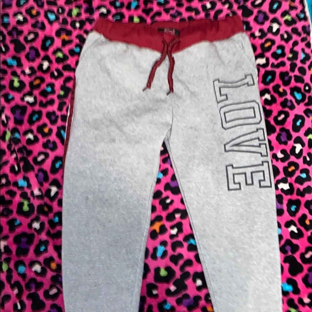 Sweatpants say love on left side